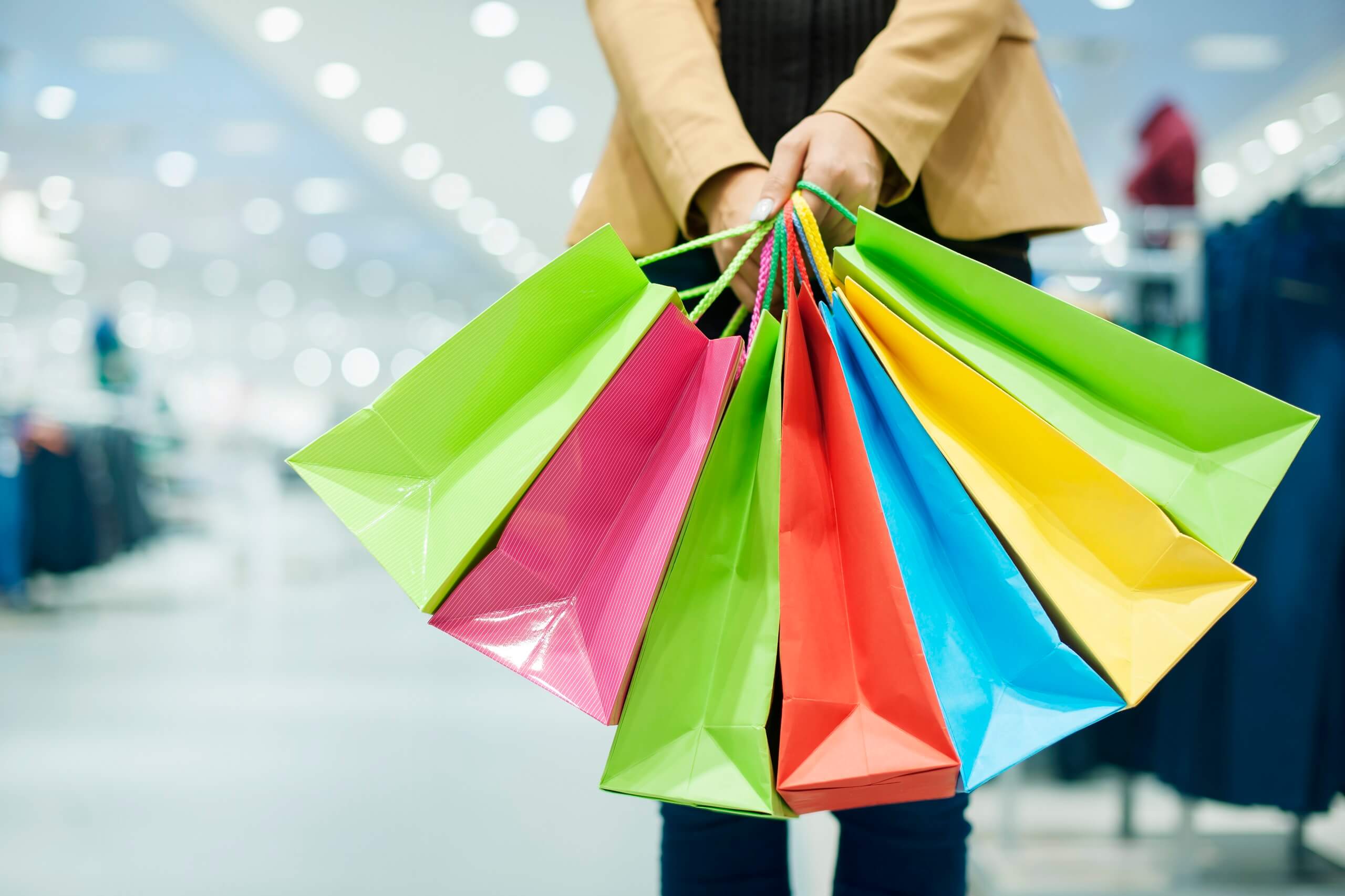 Woman holding colorful shopping bags in a department store